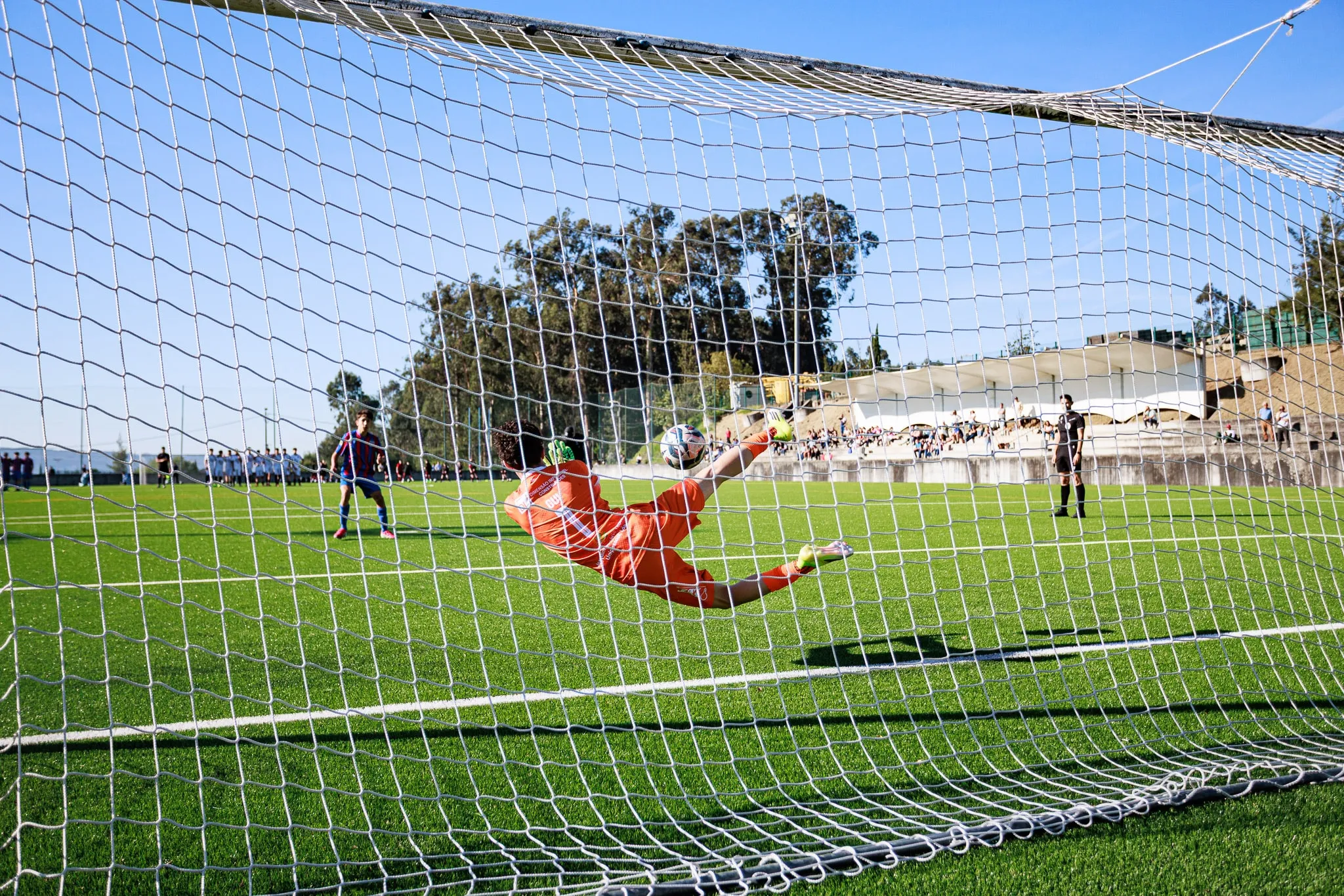 A goalkeeper makes a save during the match.