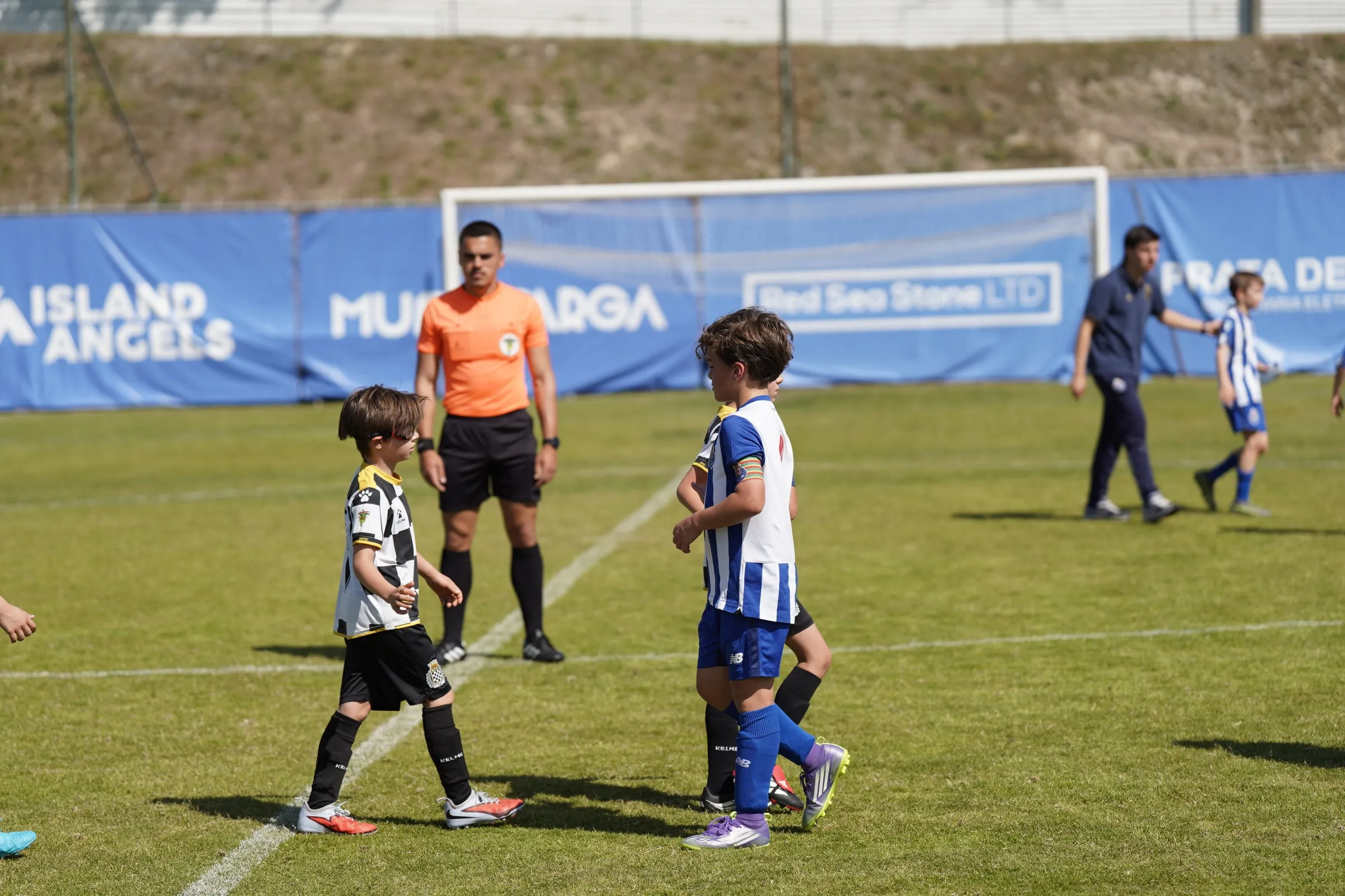 Players greet each other on the pitch.
